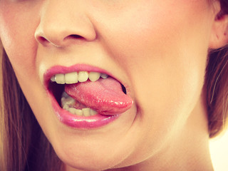 Fototapeta premium Funny blonde woman sitcking tongue out