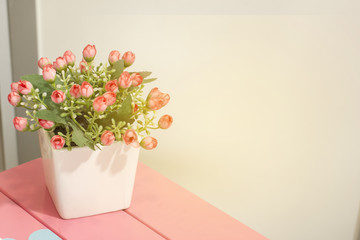 Beautiful colors of the flowers in the vase on a wooden table sweet.