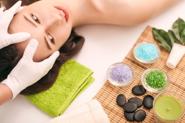 Obraz na płótnie Canvas Woman under professional facial massage in beauty spa