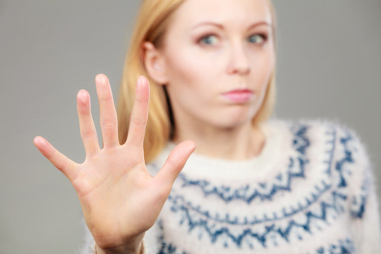Woman making stop gesture with open hand