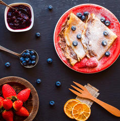 Fresh Strawberries Pancakes or Crepes with berries and chocolate