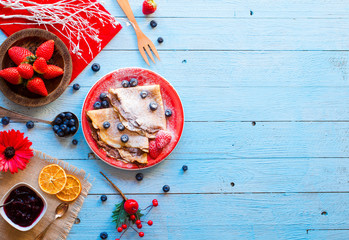 Fresh Strawberries Pancakes or Crepes with berries and chocolate