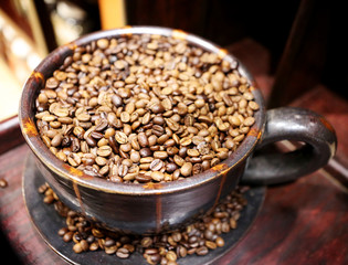 Large vintage ceramic cup full with coffee beans