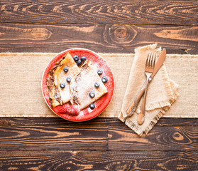 Fresh Strawberries Pancakes or Crepes with berries and chocolate