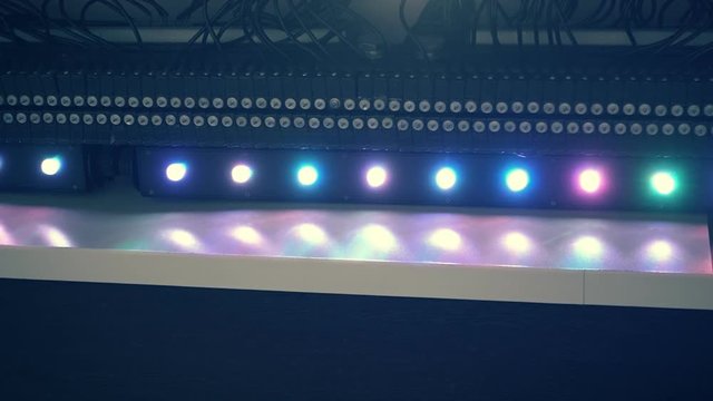Scene with water drops in multi-colored rays of light as the background for the decoration of various events