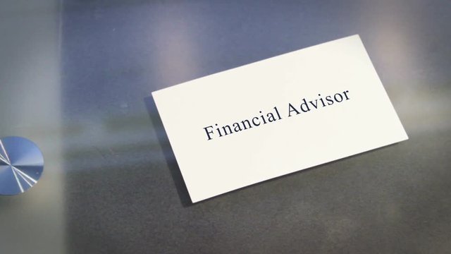 Hand puts business card on table with text Financial Advisor
