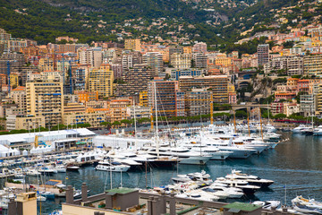 Fototapeta na wymiar Monaco, Monte Carlo. View of the seaport and the city of Monte Carlo with luxury yachts and sail boats 