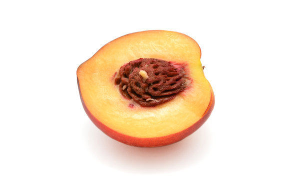 Half of peach fruit on white background