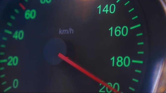 Car speedometer needle is rapidly approaching to the maximum value 200 km/h. Vehicle vibration adds adrenaline and increases the feeling of a strong acceleration