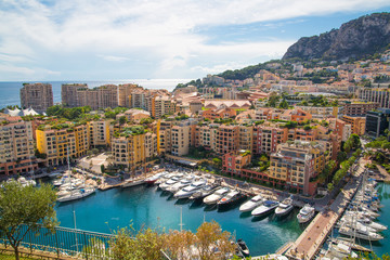 Monaco, Monte Carlo. View of the marina with luxury yachts and residential development