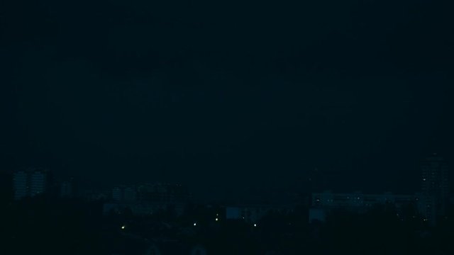 In the night the lightning strikes the ground several times in the city quarter. Slow mo, slow motion, slo mo, high speed camera, 240fps, 250fps