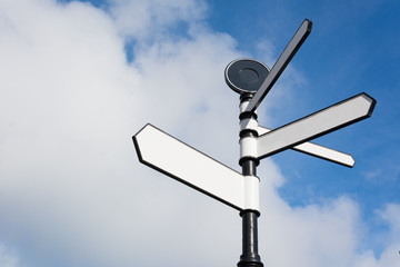 Blank Directional Signpost Arrows Over Blue Sky