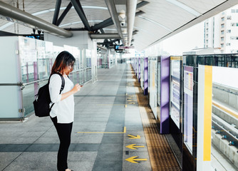 girl using smartphone sitting on metro train