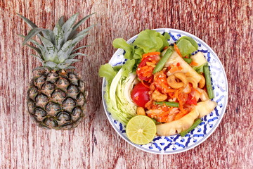 Spicy and sour vegetable salad with pineapple .