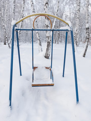 Swings covered with snow in the park