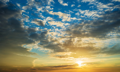 Fototapeta premium The sun and the sunset sky in the clouds.