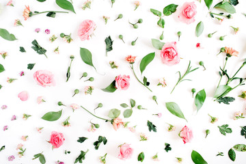 Floral pattern made of pink and beige roses, green leaves, branches on white background. Flat lay,...