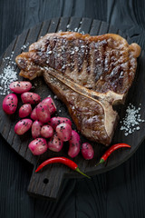 Grilled black angus club steak with fried radish, studio shot