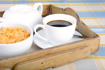 Breakfast tray with coffee and cereals.