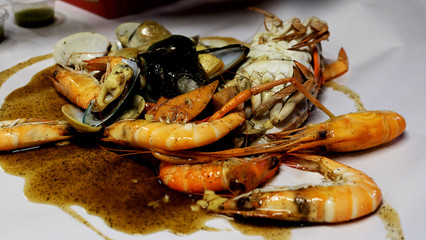 Shrimp and seafood salad with spicy sauce on white paper,Thai food for party time.