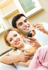 couple eating popcorn and watching TV