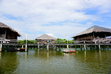 Fototapeta na wymiar Tropical riverside local cottage or straw house in Thailand