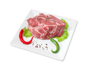 Piece of fresh uncooked pork neck, spices on square dish