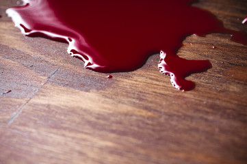A puddle of blood on a wooden background - 135023006