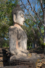 Ancient sculpture of a seated Buddha at the ruins of the Buddhist temple Wat Phra Kaeo. Kamphaeng Phet, Thailand