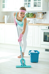 A woman cleans the house 