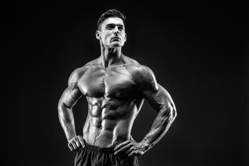 bodybuilder posing. Beautiful sporty guy male power. Fitness muscled man