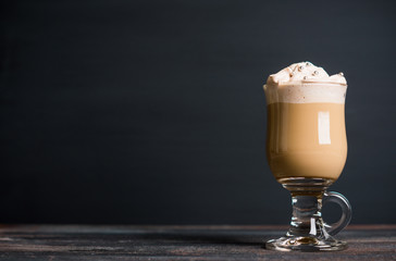 Coffee in glass on the rustic wooden background. Shallow depth of field.