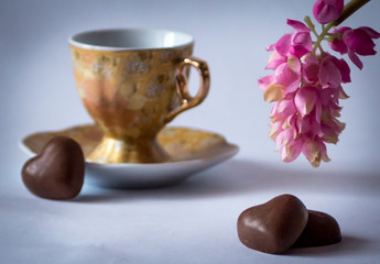 Coffee cup with candy in the form of heart