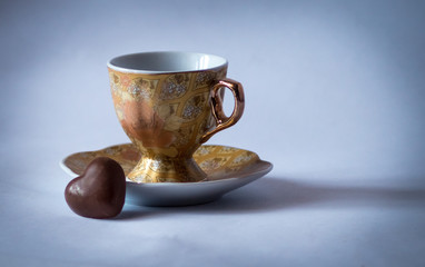 Coffee cup with candy in the form of heart