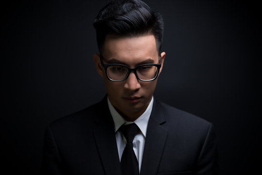Businessman in black suit on isolated black background