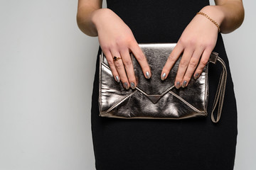 Fashion woman hold silver clutch in hand bag