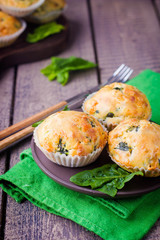 Muffins with Spinach and Cheese on Wooden Table Background. Healthy Breakfast Food Concept. Copy Space