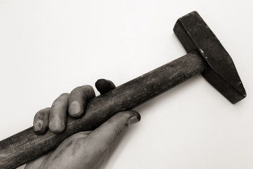 Dirty man's hand with a hammer on a white background.