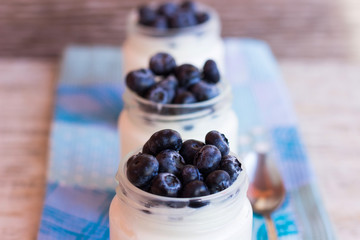 Homemade yogurt with berries in a glass jar