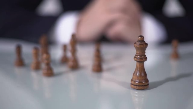 Man making winning queen move in chess game, using successful business strategy