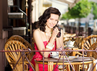 Young stylish girl in a summer cafe