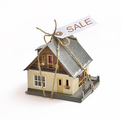 Model of an apartment house with label sale.