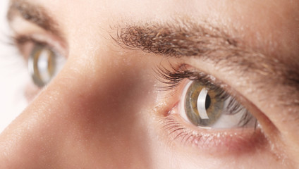 Close up view of a green man's eyes
