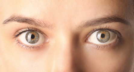 Close up view of a green woman eyes looking at camera