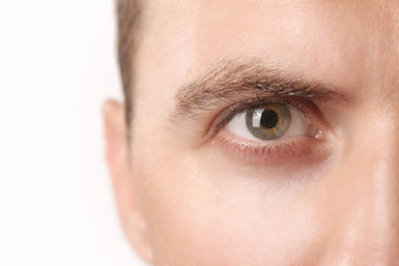 Close up view of a green man's eye looking at camera