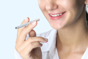 Close up portrait of young woman smoking cigarette
