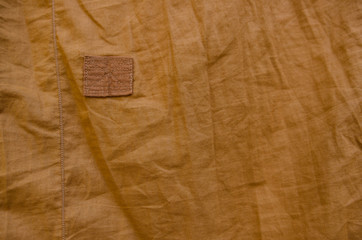 Yellow fabric and a repair point.Cloth patches and repair