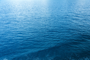 Blue sea and a moving reflection of sunlight