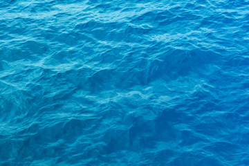 Blue sea and a moving reflection of sunlight