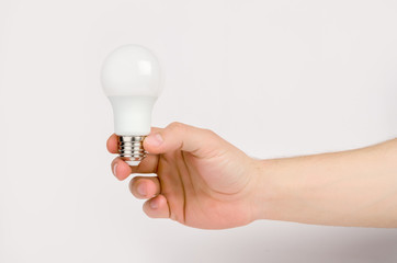 man's hand holding the LED lamp